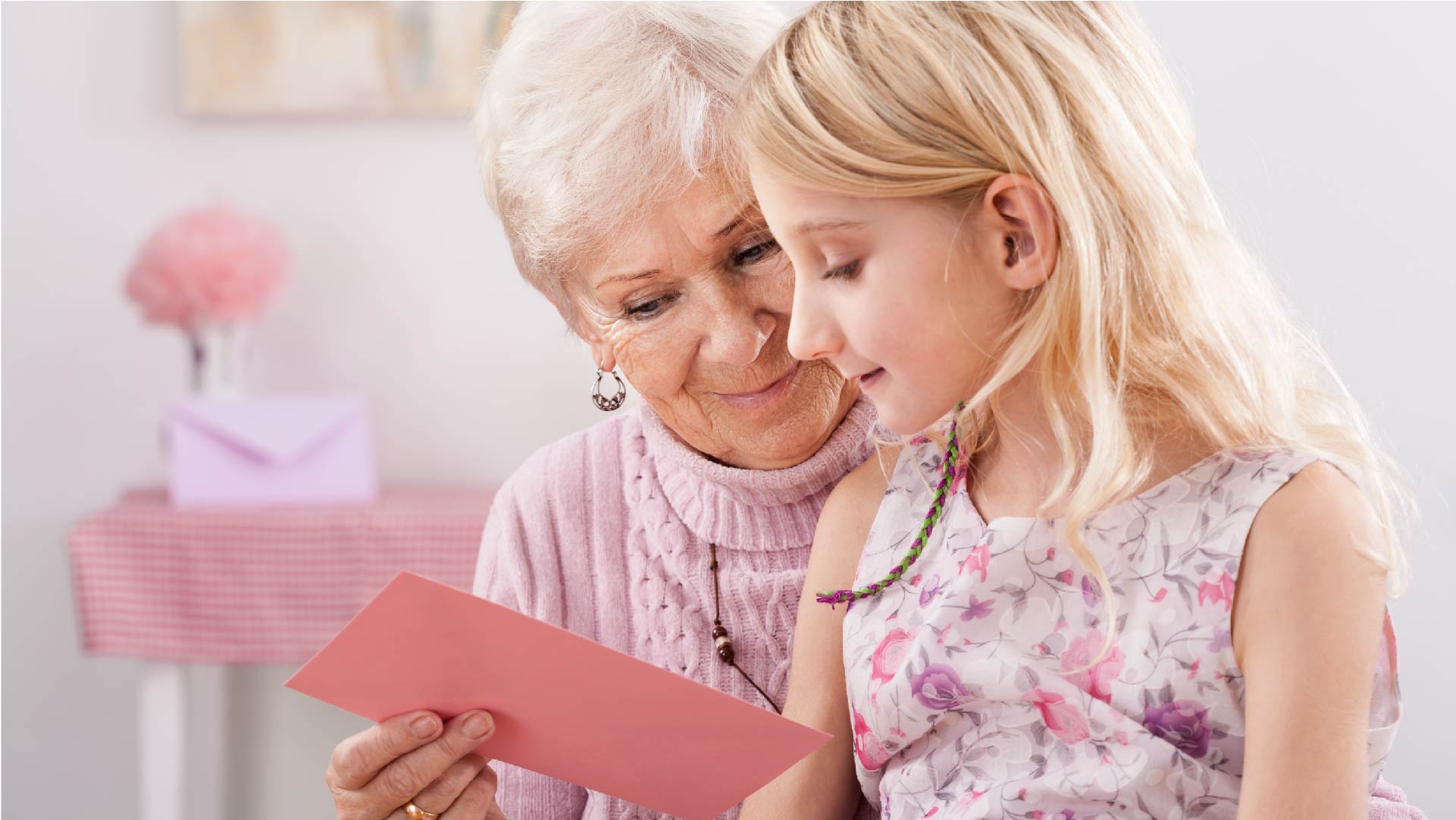 Une grand-mère remet une enveloppe à sa petite-fille