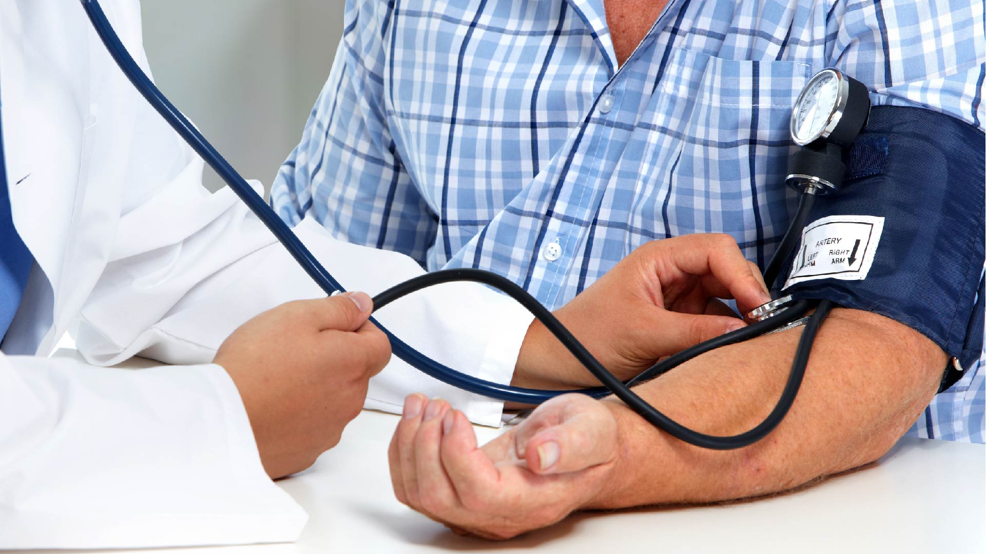 Een dokter meet de bloeddruk van een patiënt