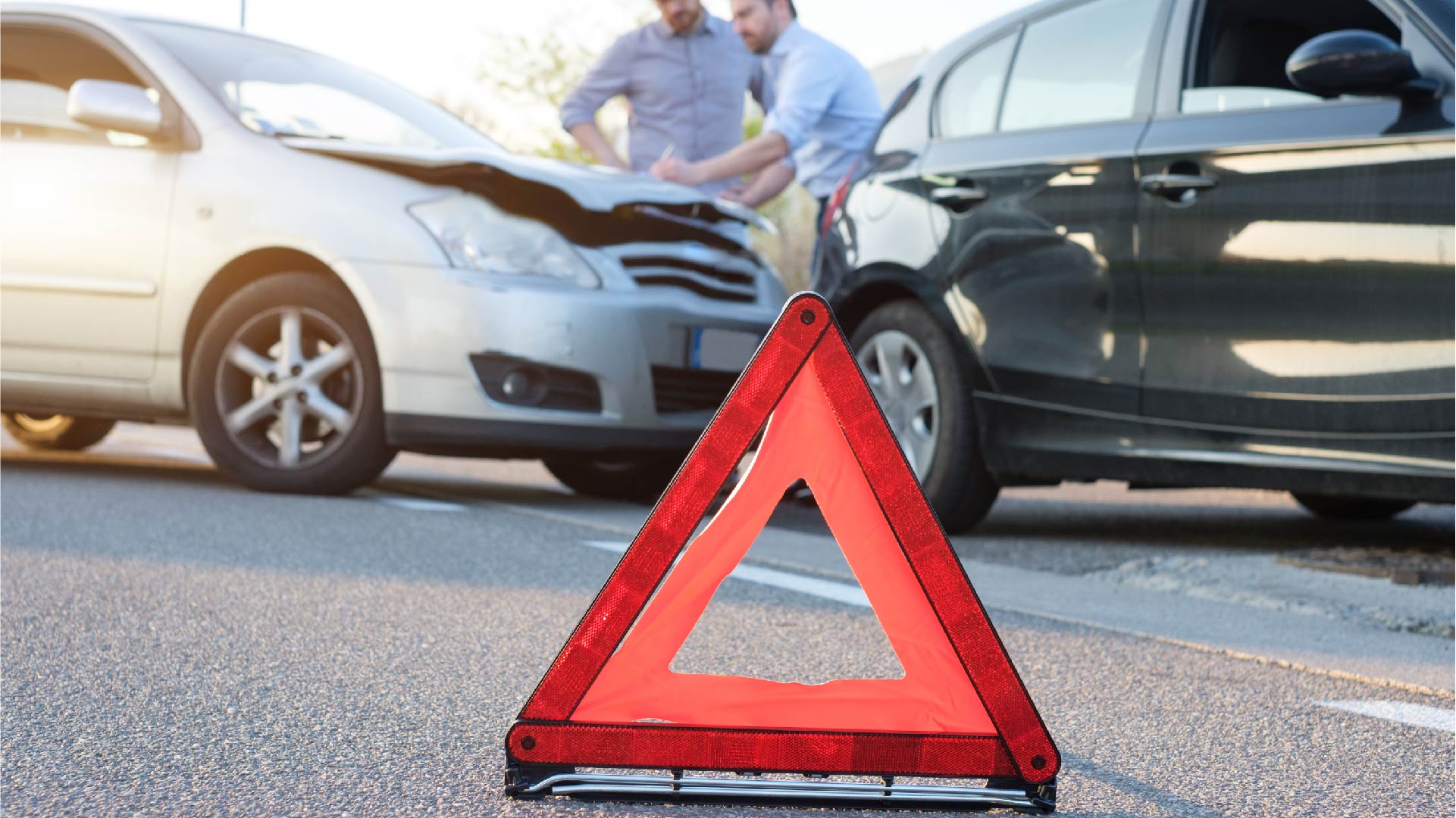 Deux hommes remplissent le constat d&#039;assurance après un accident