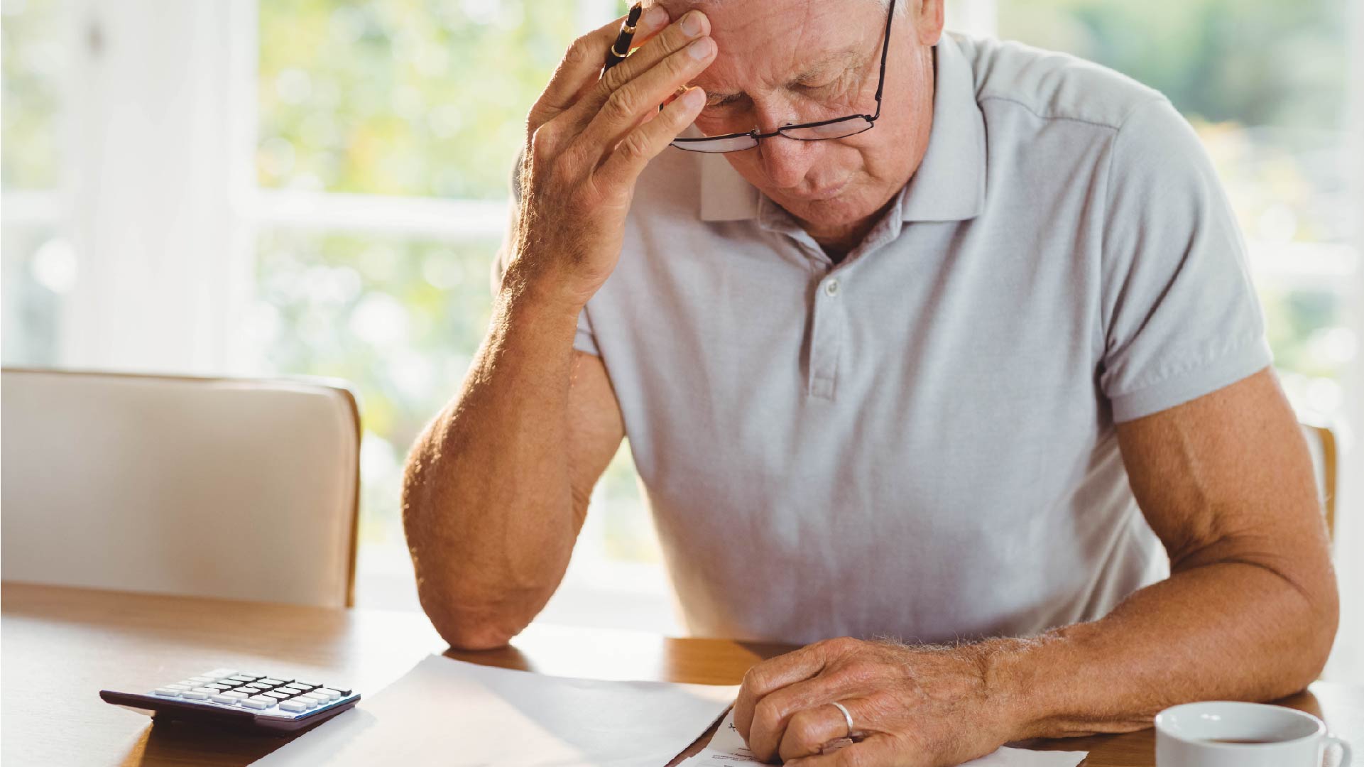 Een man met papieren en documenten om zijn belastingaangifte in te vullen