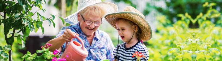 grandmother-granddaughter-watering-plants_1.jpg